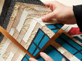 Caitlin Cary arranges needleprint pieces into a piece of art.