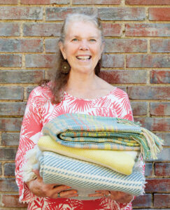 Judi Jetson holds a stack of Blue Ridge Blankets