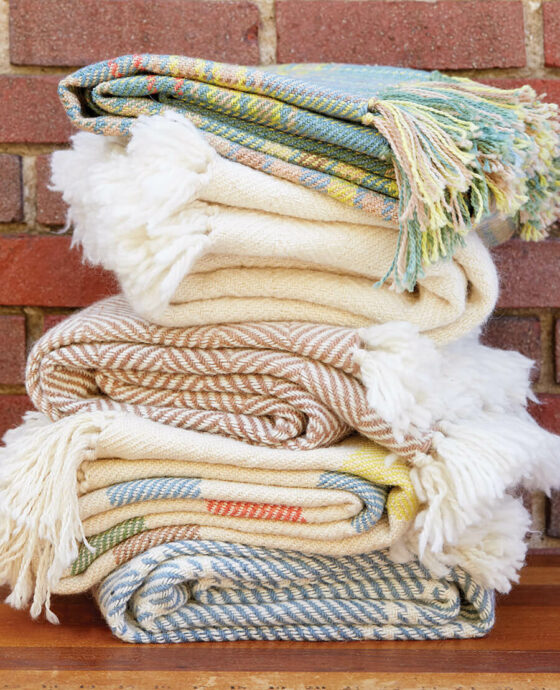 Stack of blankets made by Local Cloth in the Asheville River Arts District