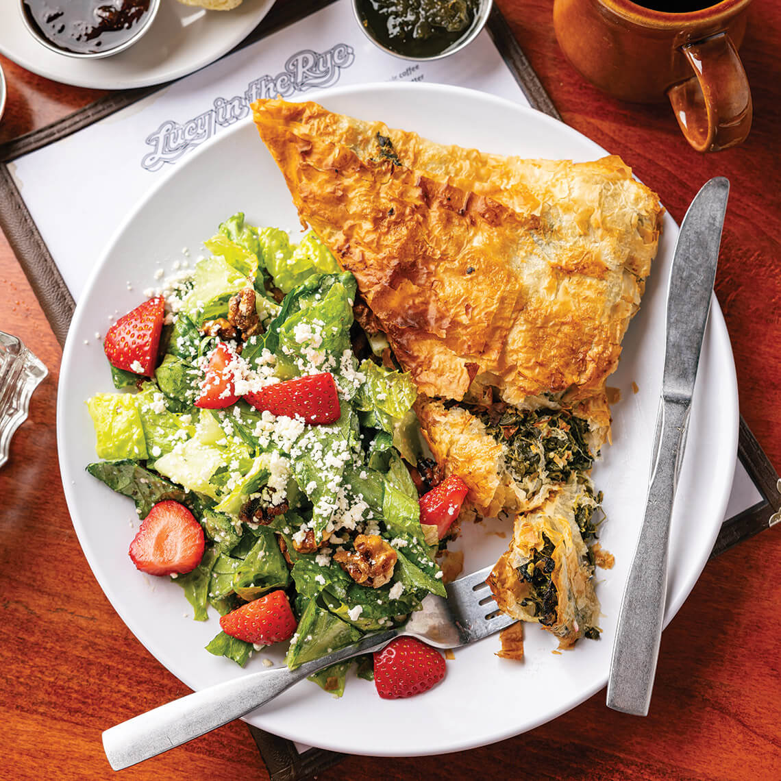 Plate of spinach phyllo pie and side salad at Lucy in the Rye