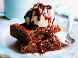 Brownies topped with ice cream and hot fudge
