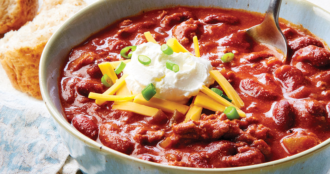Chili topped with sour cream and cheese