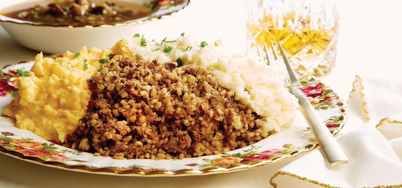 A traditional Burns Night dinner includes a platter of haggis, neeps, tatties, and cock-a-leekie soup