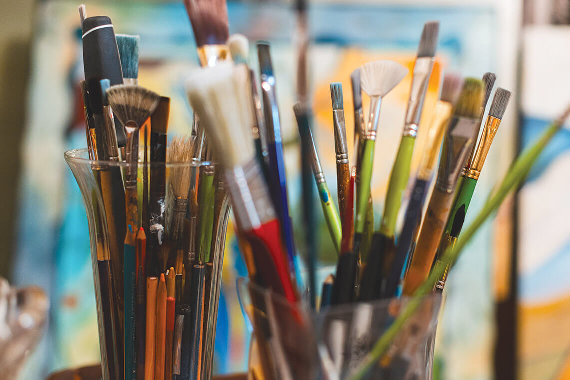 Assorted paintbrushes and other artist tools