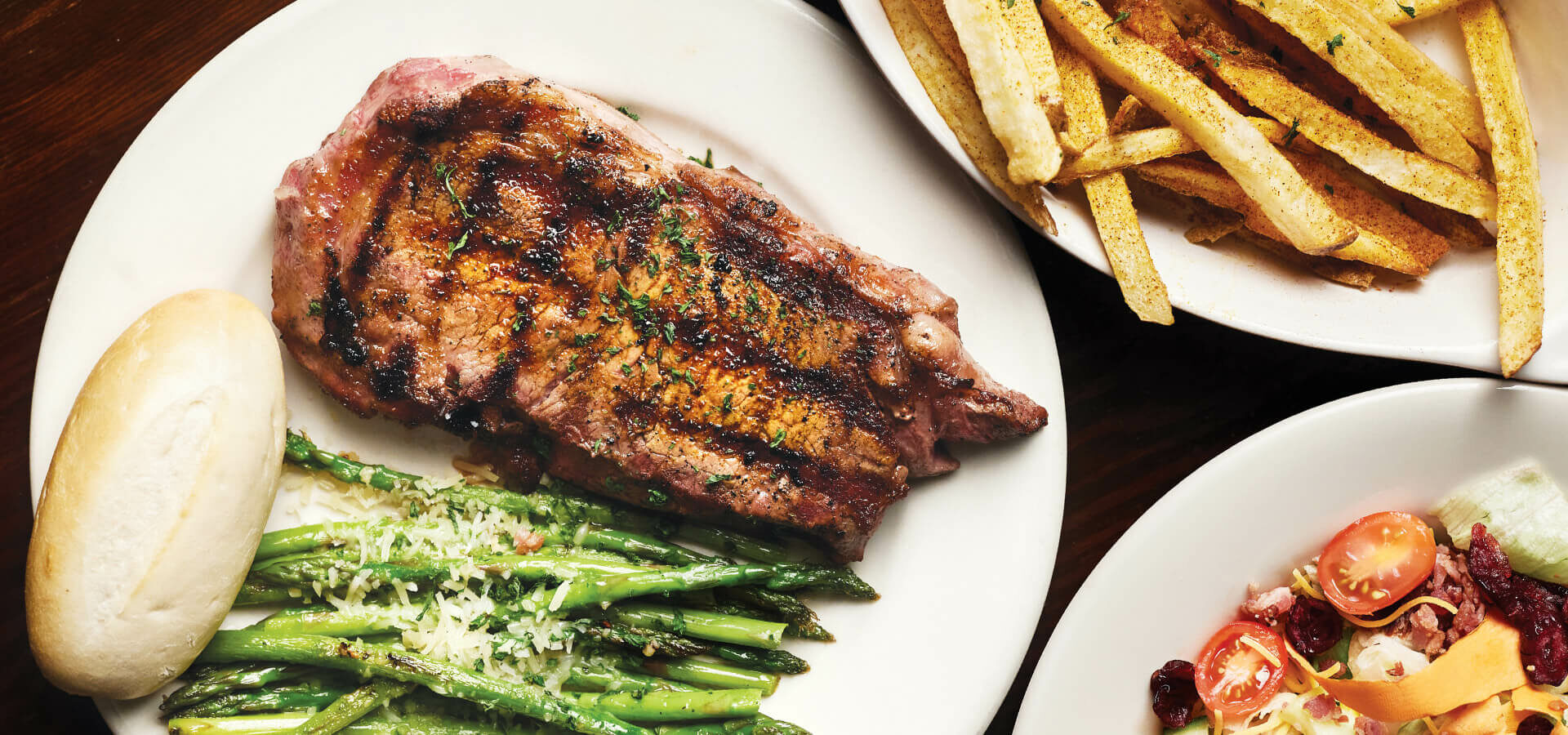 Plate of steak with green beans and fries, served at Kimber's Steakhouse