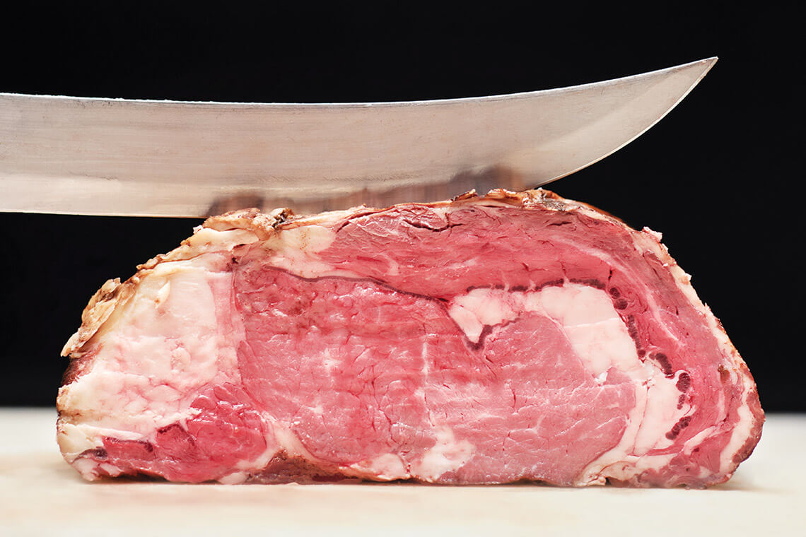 Knife slicing prime rib at Kimber's Steakhouse