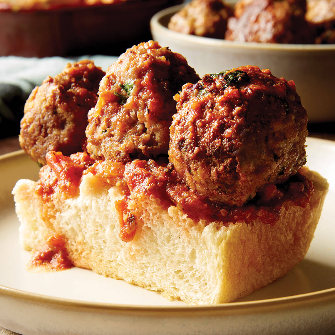 Focaccia bread topped with three meatballs and sauce