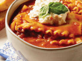 Bowl of lasagna soup topped with ricotta.