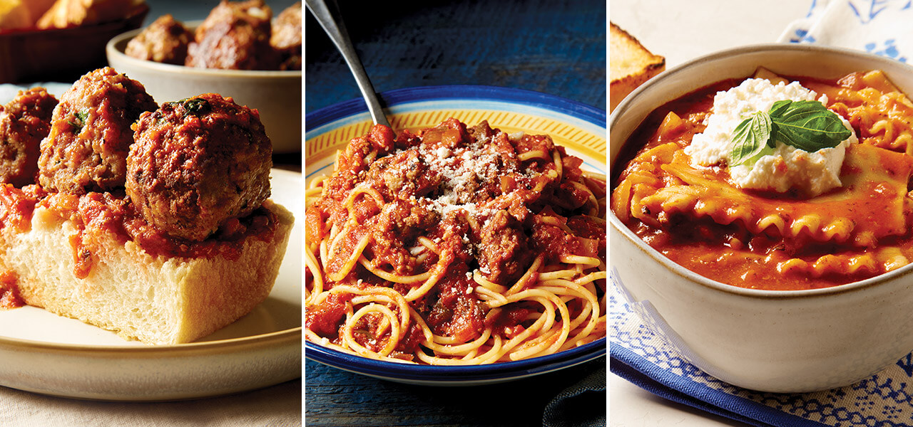Focaccia topped with meatballs, bowl of spaghetti with sauce, bowls of lasagna soup