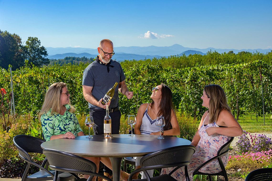 People attend a wine tasting at Marked Tree Vineyard
