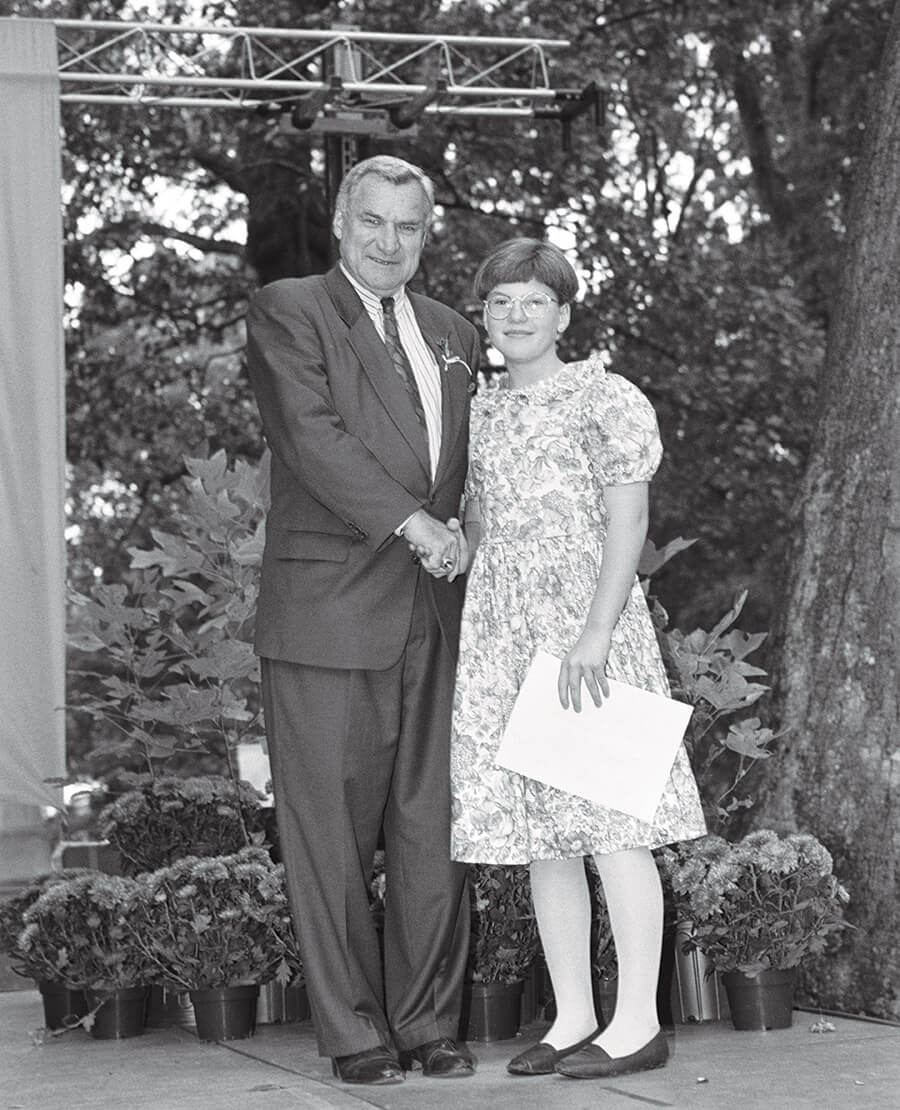 Erin Lowder as a sixth grader with Dean Smith at UNC Chapel Hill