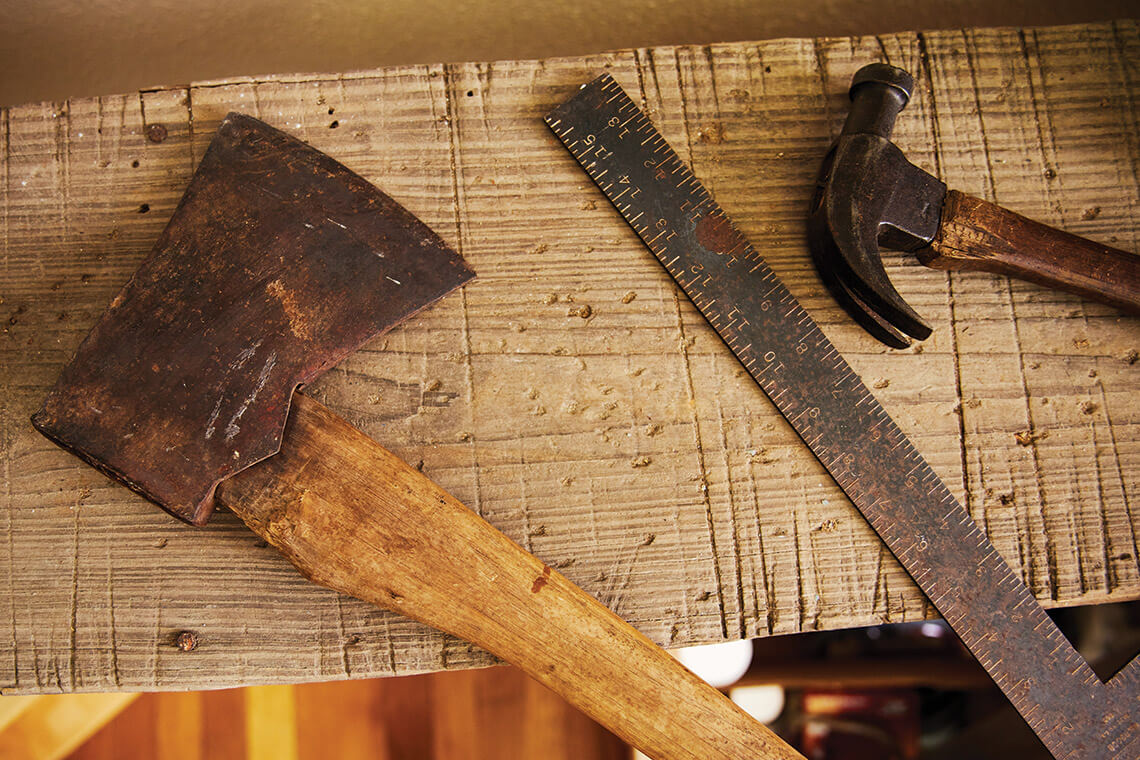 Axe, ruler, and hammer are a few of Doc Watson's old carpentry tools.