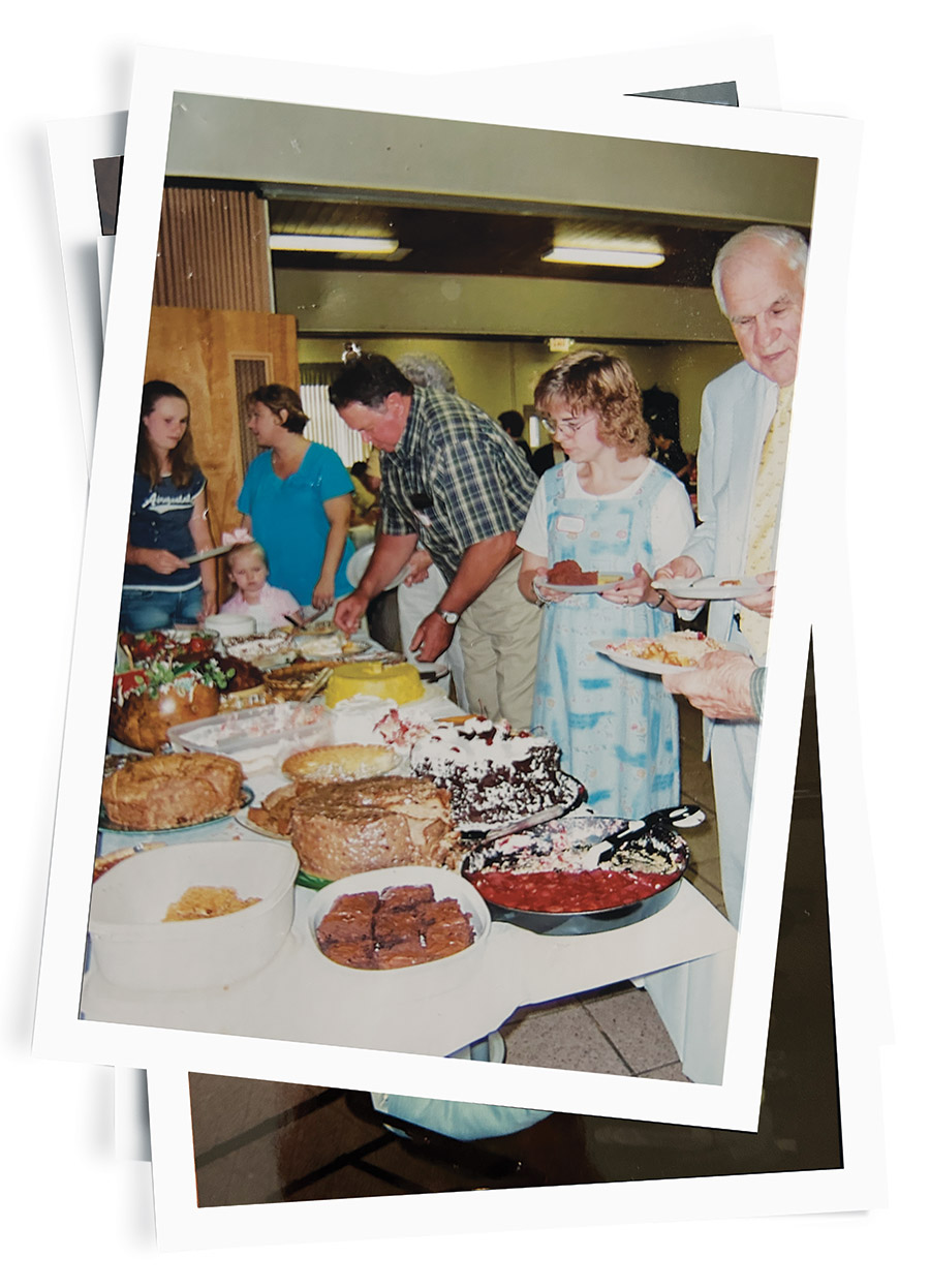 Old family photo of the Snow family gathered around the dessert table