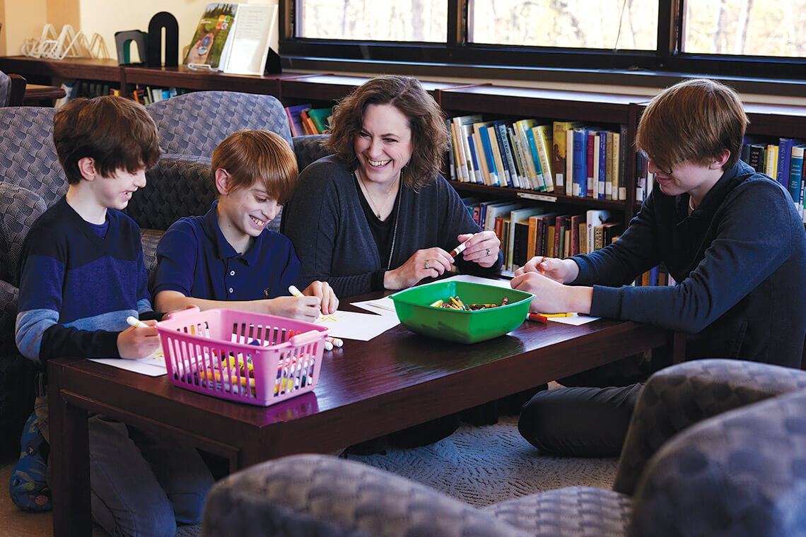 Karen Brod and her kids make cards for senior citizens during Project Hamantaschen at Temple Emanuel