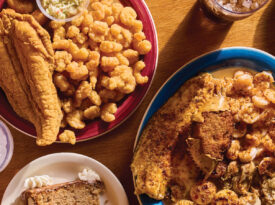 Platters of fried fish and slices of cake on the table at Walkertown Seafood Shack