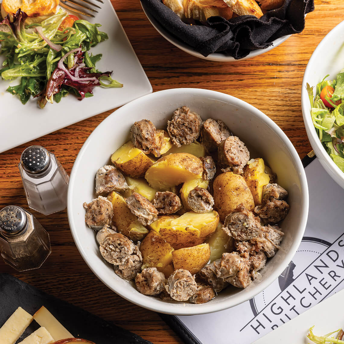 Bowl of soutisso sausage and potatoes from Highlands Butchery