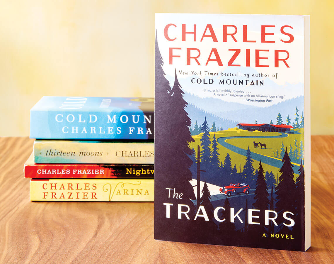 Stack of Charles Frazier's books including The Trackers, Cold Mountain, Thirteen Moons, Nightwood, and Varina.