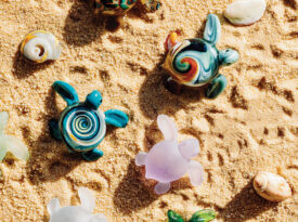 Jim Downey's glass sea turtles in the sand.