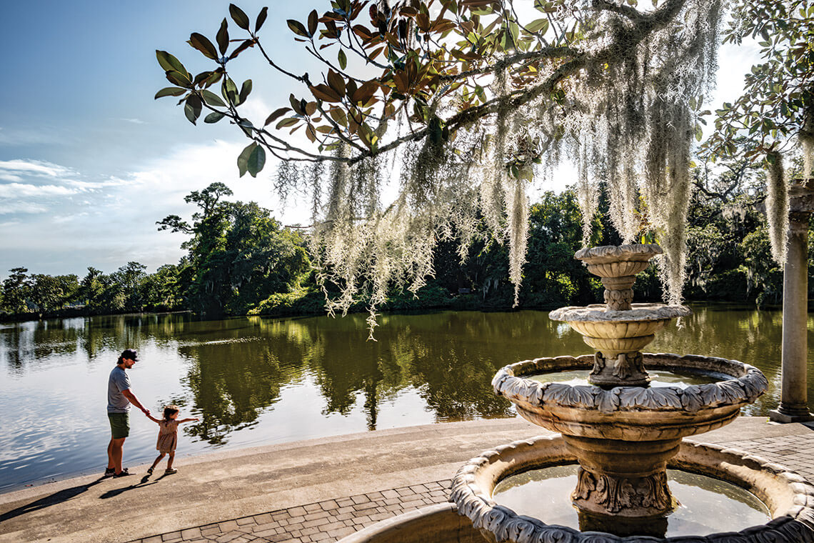 A parent and child walk along the concrete steps that lead to Airlie Lake.
