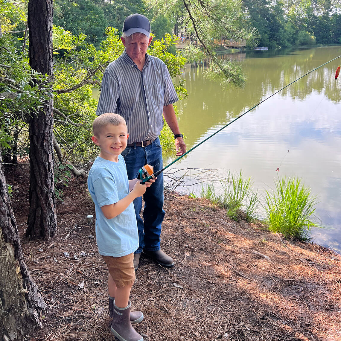 Man and child go fishing in Surf City.
