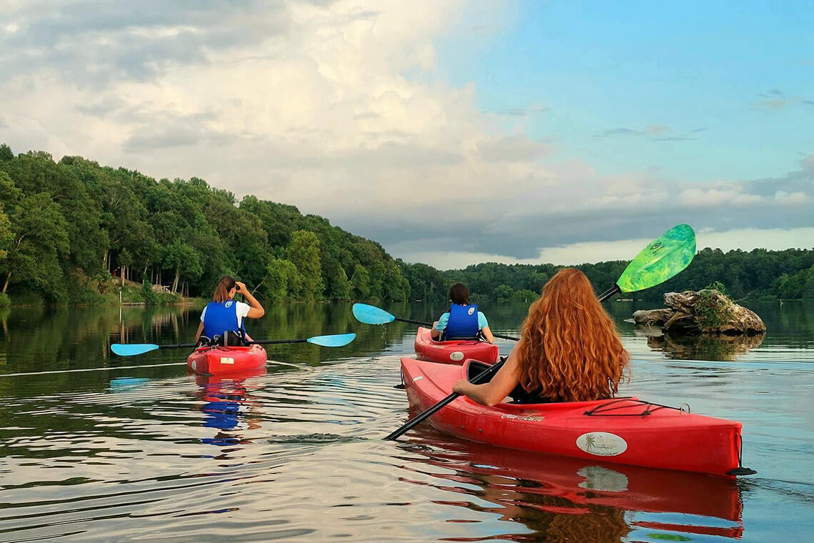 People kayaking in Lake Saxapahaw in Alamance County, NC