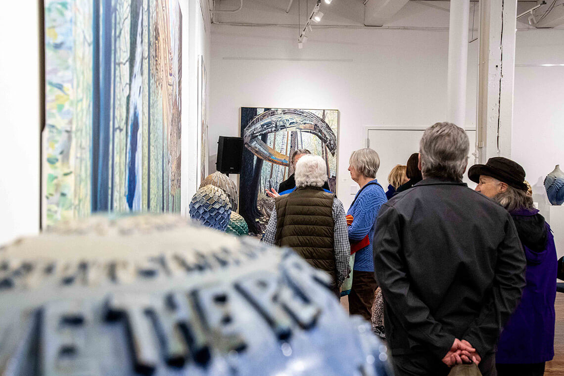 Visitors view art in the Eno Arts Mill Gallery