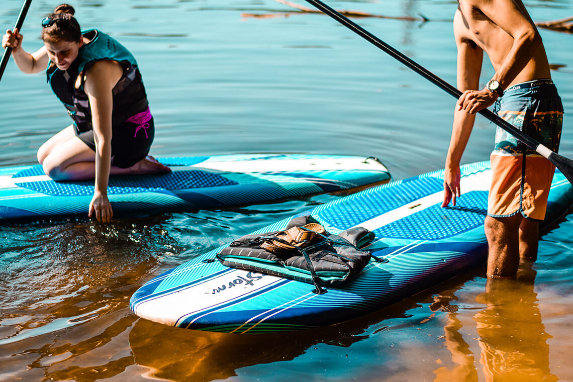 People launch their paddleboards