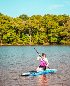 Woman paddleboards in Mountain Island Lake