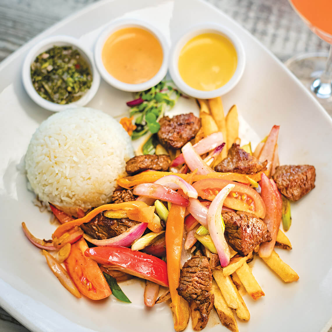 Lomo saltado with rice and different sauces