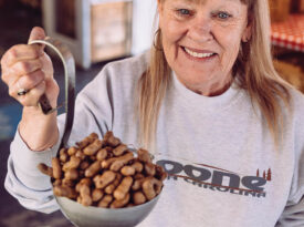 Karen McCard holds up a giant ladle full of boiled peanuts