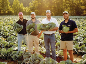 Will Kornegay and his childhood friends Billy McDaniel, Phillip Watson, and Peyton McDaniel holding heads of cabbage at a farm.