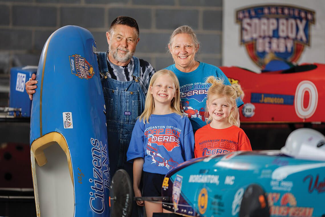 Tommy and Marylin Waters and their granddaughters Bexley Fredrickson and Hazel Palmer and their racecars.