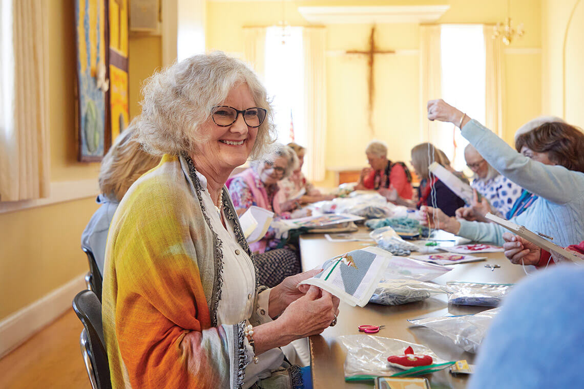 Fran Reynolds and volunteers stitch kneelers at St. Paul's Episcopal Church