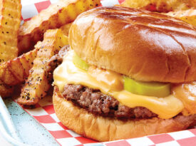 Smash cheeseburgers and pepper crinkle cut fries on a tray