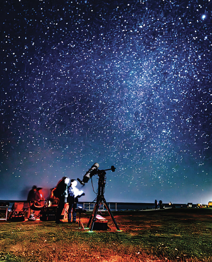 Members of the Crystal Coast Stargazers observe the night sky at Cape Lookout