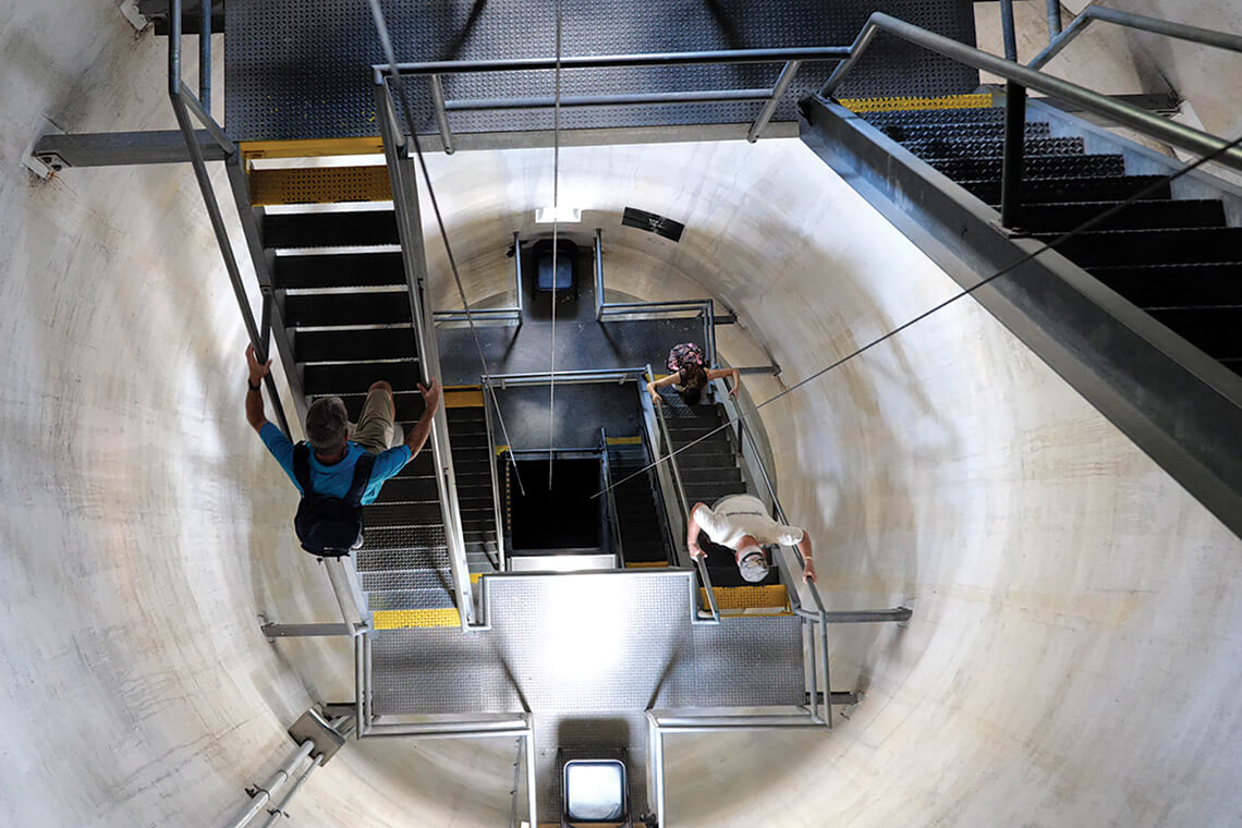 People climb the ladders inside the Oak Island Lighthouse
