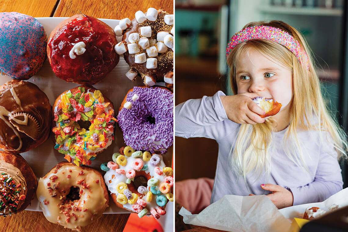 Bock of doughnuts from Wake N Bake; little girl takes a bite of a doughnut