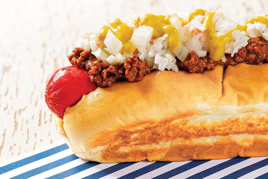 Carolina Dog topped with chili, slaw, and mustard