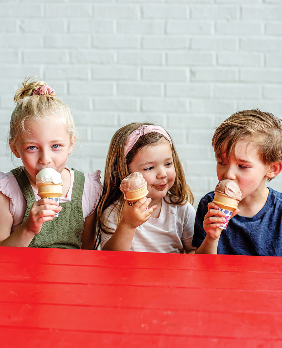 Three children with lick cones at Whit's Frozen Custard