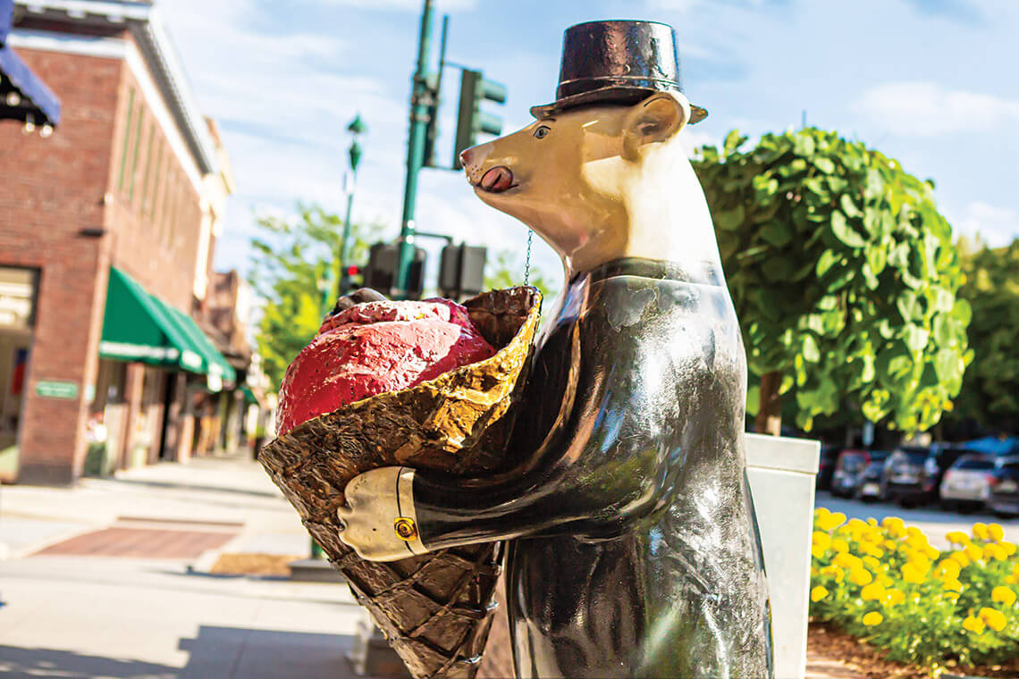One of Hendersonville’s iconic bear statues greets guests outside Kilwins.