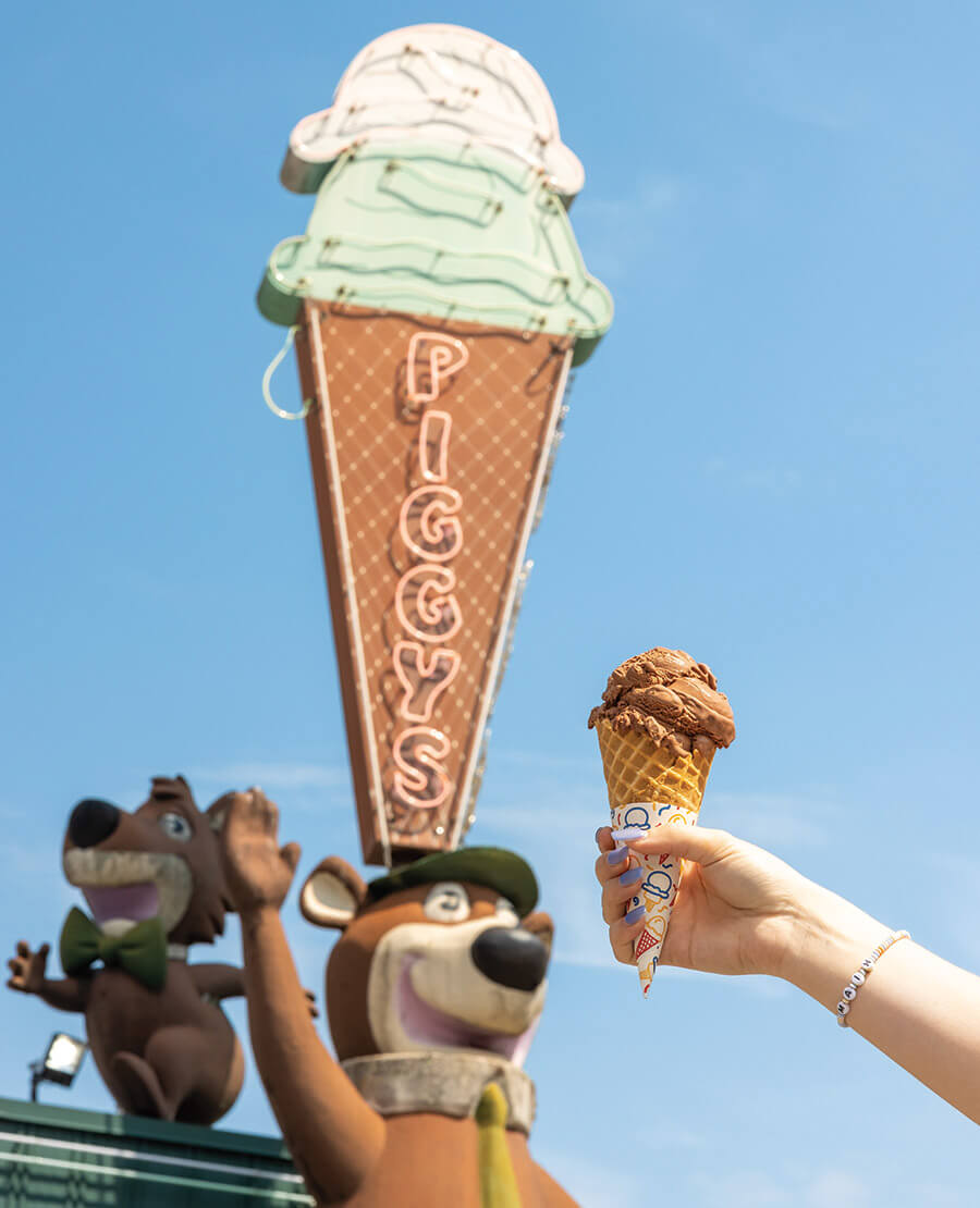 Hand holds a cone of ice cream outside of Piggy's in Hendersonville, NC