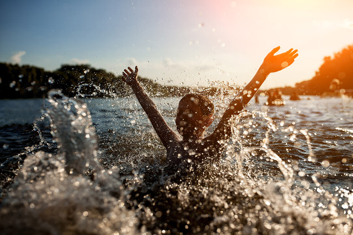 Child playing in lake waters