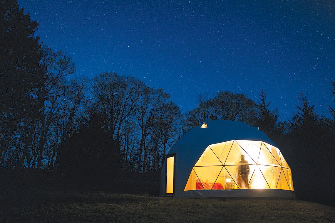 The writer inside the Stargazer Domes at Blue Bear Mountain Camp
