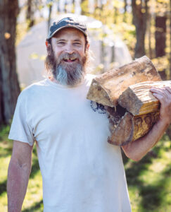 Kevin Quick carrying firewood
