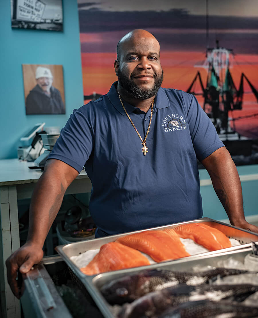 Captain John Mallette with trays of fresh fish fillets at Southern Breeze Seafood