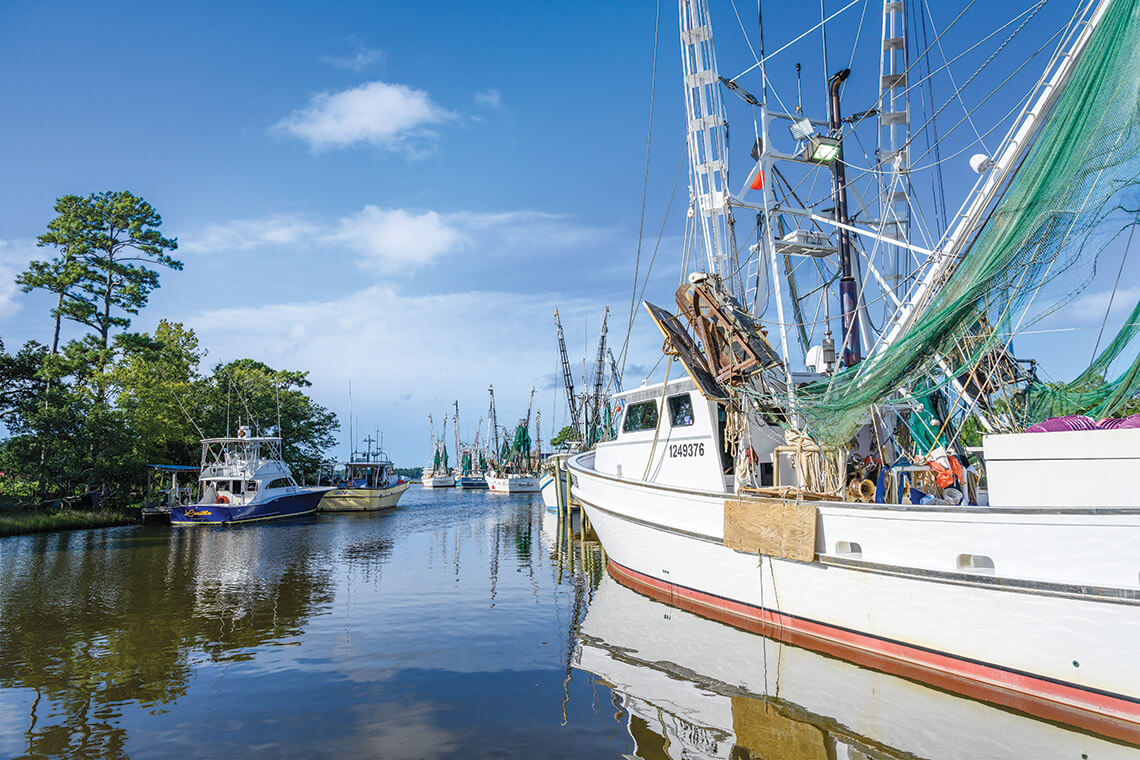 Shrimp trawlers motor out of Sneads Ferry