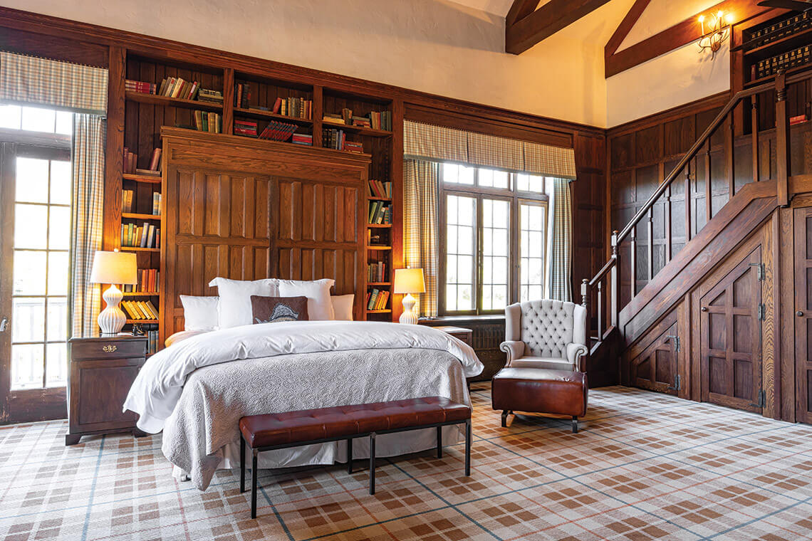 The bed and bookshelves in The Greystone Inn's Rockefeller Suite