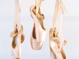 Pointe ballet slippers hang from a barre at Louis Nunnery School of Ballet in Hickory NC