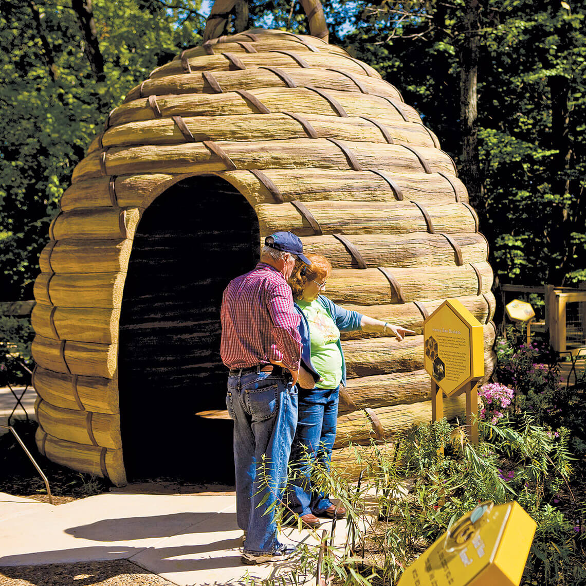 Couple outside of the 10-feet-tall replica hive at the NC Zoo. 