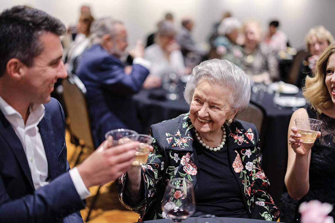 Phyllis Dunning raises a glass along with Jonathan Nicolas and Katie Hall
